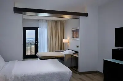 a hotel room with a bed and a balcony at Fairfield Inn & Suites by Marriott Denver Downtown in Denver