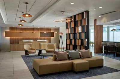 a lobby of a hotel with a couch and a bar at Fairfield Inn & Suites by Marriott Denver Downtown in Denver