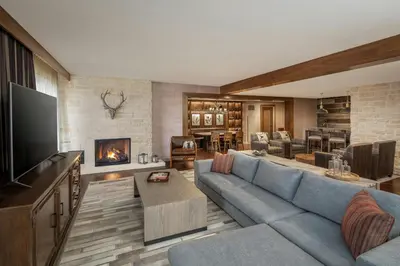a living room with a blue couch and a fireplace at Gaylord Rockies Resort & Convention Center in Aurora