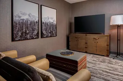 a living room with a couch and a tv at Gaylord Rockies Resort & Convention Center in Aurora