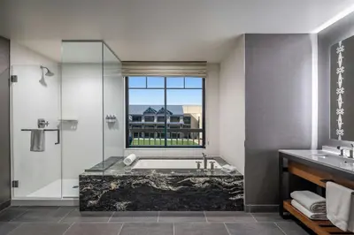a bathroom with a tub and a window at Gaylord Rockies Resort & Convention Center in Aurora
