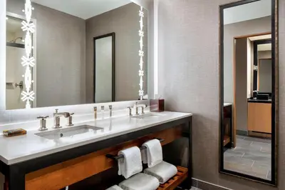 a bathroom with a sink and a mirror at Gaylord Rockies Resort & Convention Center in Aurora