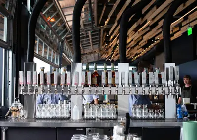 a bar with a bunch of bottles and glasses at The Source Hotel in Denver