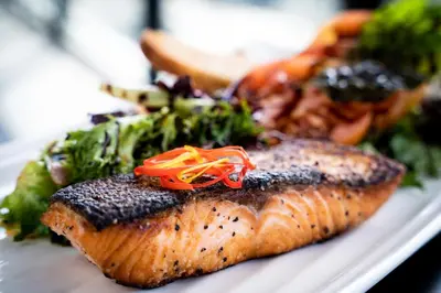 a plate of food with fish and vegetables on it at The Source Hotel in Denver