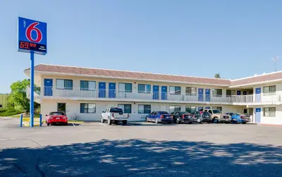 a hotel with cars parked in a parking lot at Motel 6 Thornton in Thornton