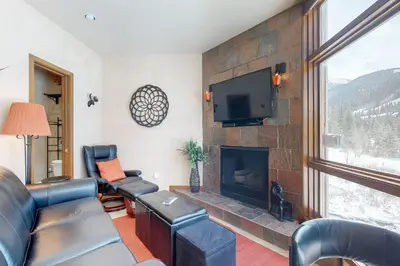 a living room with a couch and a fireplace at 2914 River Bank Lodge - Keystone in Keystone