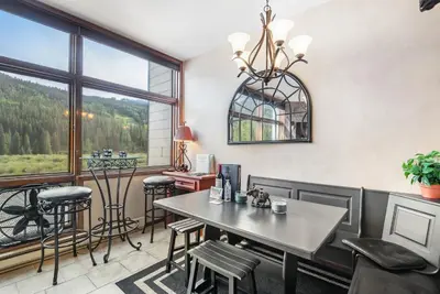 a dining room with a table and chairs and a window at 2914 River Bank Lodge - Keystone in Keystone