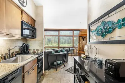 a kitchen with a sink and a stove top oven at 2914 River Bank Lodge - Keystone in Keystone