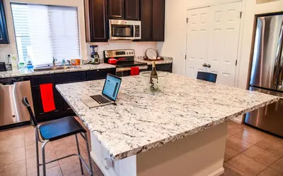 a kitchen with a counter top with a laptop on it at Den Haven Entire Home Near DIA With Three Bedrooms And Private En Suite Baths in Denver
