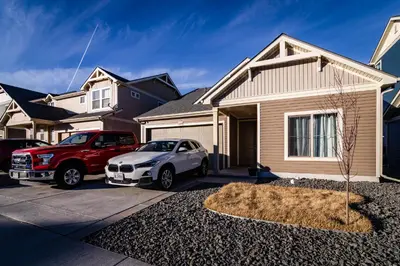 two cars parked in front of a house at Den Haven Entire Home Near DIA With Three Bedrooms And Private En Suite Baths in Denver