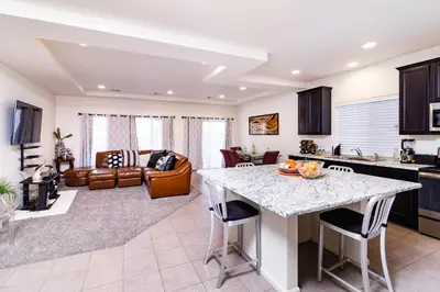 a kitchen and living room with a table and chairs at Den Haven Entire Home Near DIA With Three Bedrooms And Private En Suite Baths in Denver