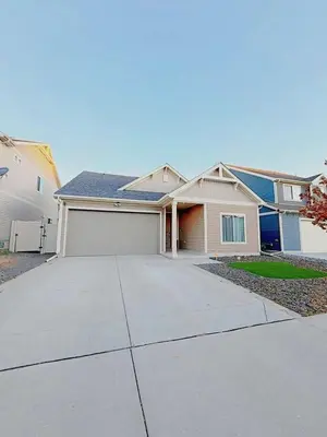 a house with a driveway and a garage at Den Haven Entire Home Near DIA With Three Bedrooms And Private En Suite Baths in Denver