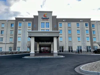 a building with a sign on the front of it at Comfort Suites Denver International Airport in Denver