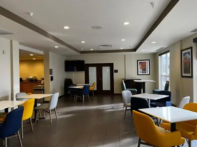 a dining room with tables and chairs and tablesktop at Comfort Suites Denver International Airport in Denver