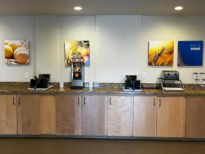 a bar in a hotel room with a cash register at Comfort Suites Denver International Airport in Denver