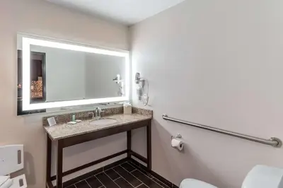 a bathroom with a sink and a mirror at MainStay Suites Denver International Airport in Denver