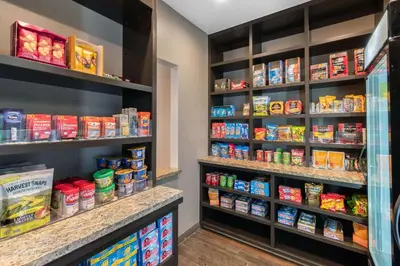 a grocery store aisle with shelves of food at MainStay Suites Denver International Airport in Denver