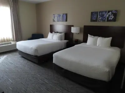 a hotel room with two beds and a window at Sleep Inn & Suites Denver International Airport in Denver