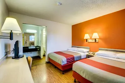 a hotel room with two beds and a television at Motel 6-Wheat Ridge, CO - West - Denver North in Wheat Ridge