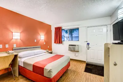 a hotel room with a bed and a television at Motel 6-Wheat Ridge, CO - West - Denver North in Wheat Ridge