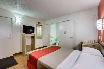 a hotel room with a bed and a bathroom at Motel 6-Wheat Ridge, CO - West - Denver North in Wheat Ridge