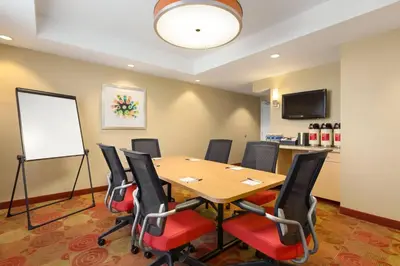 a conference room with a table and chairs at TownPlaces Suite Denver Airport at Gateway Park in Denver