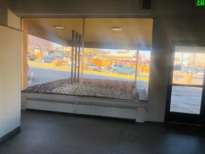 a store window with a view of a parking lot at Budget Inn Denver Downtown in Denver