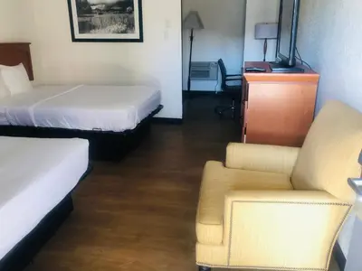 a hotel room with a bed and a chair at Budget Inn Denver Downtown in Denver