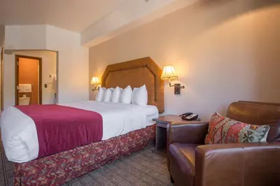 a hotel room with a bed and a couch at Table Mountain Inn in Golden