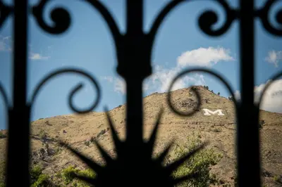 a view of a mountain through a iron fence at Table Mountain Inn in Golden