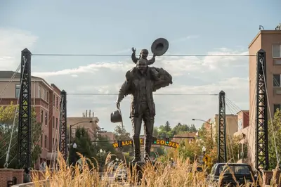 a statue of a man standing in a city at Table Mountain Inn in Golden