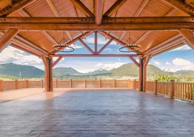 a large wooden deck with mountains in the background at The Estes Park Resort in Estes Park