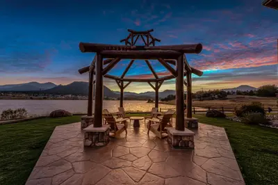 a gazebo with a table and chairs on the grass at The Estes Park Resort in Estes Park