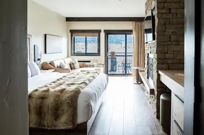 a bedroom with a large bed and a living room at The Estes Park Resort in Estes Park