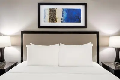 a bedroom with a white bed with two lamps at Lady Luck Casino Black Hawk in Black Hawk