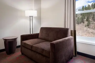 a chair sitting next to a window in a room at Lady Luck Casino Black Hawk in Black Hawk