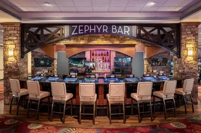 a bar in a casino with a bunch of chairs at Lady Luck Casino Black Hawk in Black Hawk