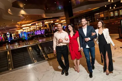 a group of people walking down a dance floor in a casino at Lady Luck Casino Black Hawk in Black Hawk
