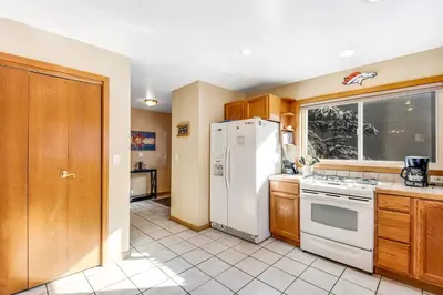 a kitchen with a white refrigerator and a window at Twenty Grand Chalet in Silverthorne