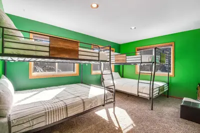 two bunk beds in a room with green walls at Twenty Grand Chalet in Silverthorne