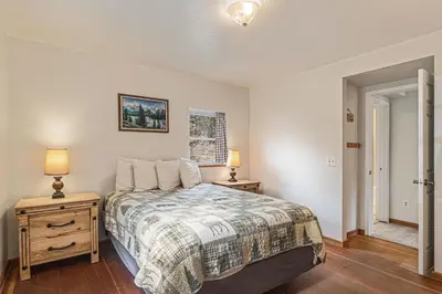 a bedroom with a bed and two night stands at Blue Jay Bungalow in Estes Park