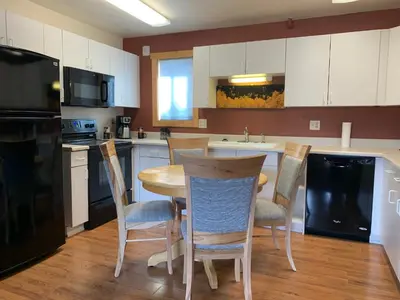 a kitchen with a table and chairs in it at Hotel Estes in Estes Park
