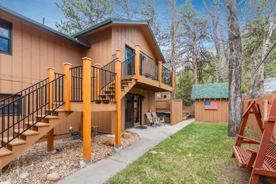 a house with a staircase on the side of it at 4 Seasons Inn on Fall River in Estes Park