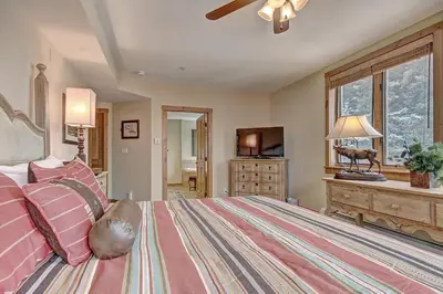 a bedroom with a large bed and a window at 3069 Timbers Condo in Keystone