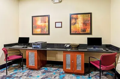 a office with a desk with two computers and two chairs at La Quinta by Wyndham Denver Gateway Park in Denver