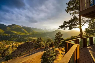 a balcony of a house with a view of the mountains at Divine Condominium 3 Bedroom condo in Estes Park