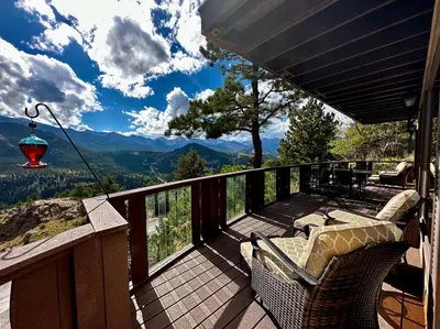 a balcony with chairs and a view of the mountains at Divine Condominium 3 Bedroom condo in Estes Park
