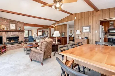 a large living room with a table and chairs at Macmillan Home in Estes Park