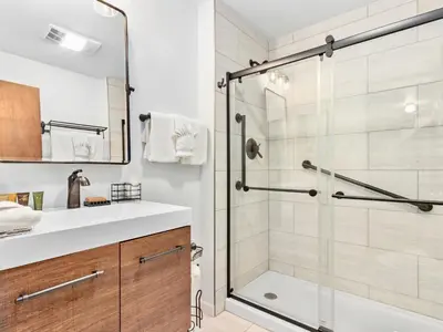 a bathroom with a shower and a white sink at Macmillan Home in Estes Park