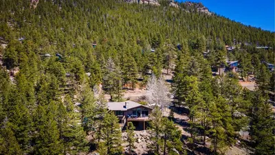 an aerial view of a house on the side of a mountain at Macmillan Home in Estes Park